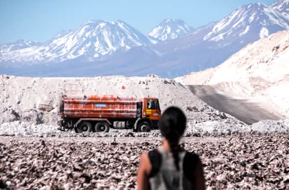Mujer contempla la extracción de litio en el salar de Atacama en los Andes, Chile