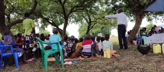 Conversación al aire libre en una comunidad, sobre el peligro de la explotación petrolífera