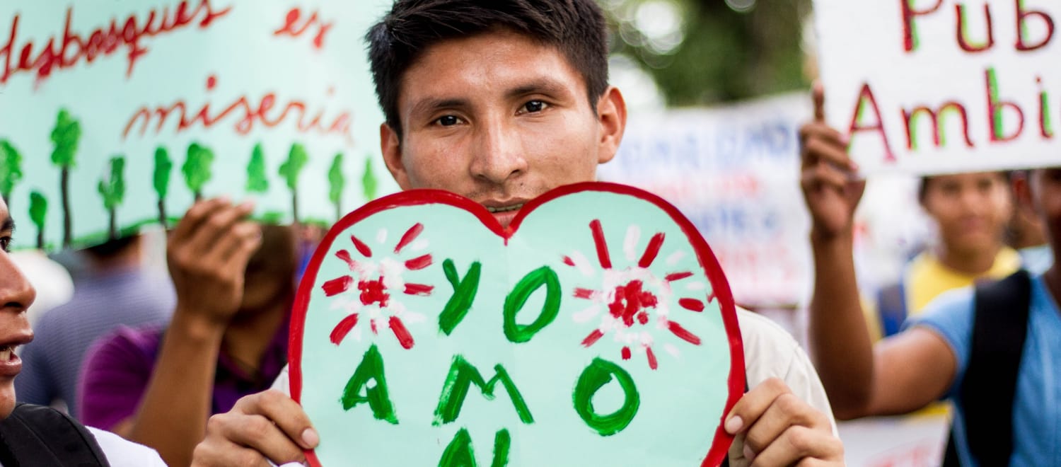 Manifestante con pancarta "Yo amo al bosque" en Iquitos, Perú